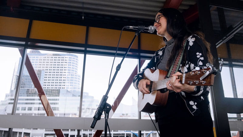 A busker performing music at the SeaBus terminal